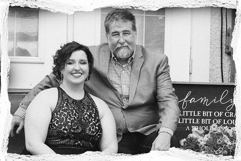 dad and daughter sitting on a step.