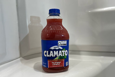 a full page advertisement spread of a tomatoe mermaid in a caesar cocktail